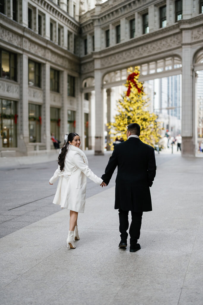 Couples winter downtown Chicago engagement photos at the Wrigley Building