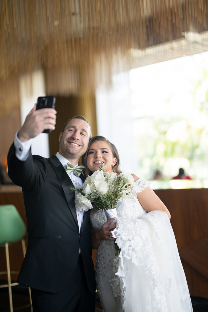 Bride and groom taking a selfie at TRS Coral Hotel during their destination Grand Palladium Costa Mujeres wedding