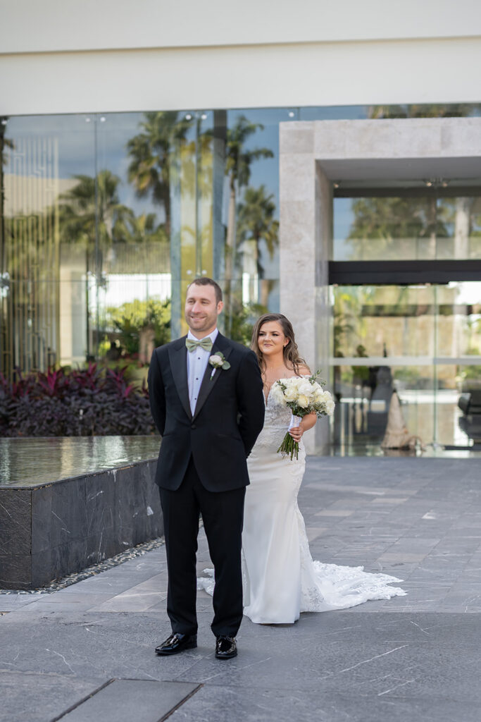 Bride and groom sharing a first look outside of TRS Coral Hotel during their destination Grand Palladium Costa Mujeres wedding
