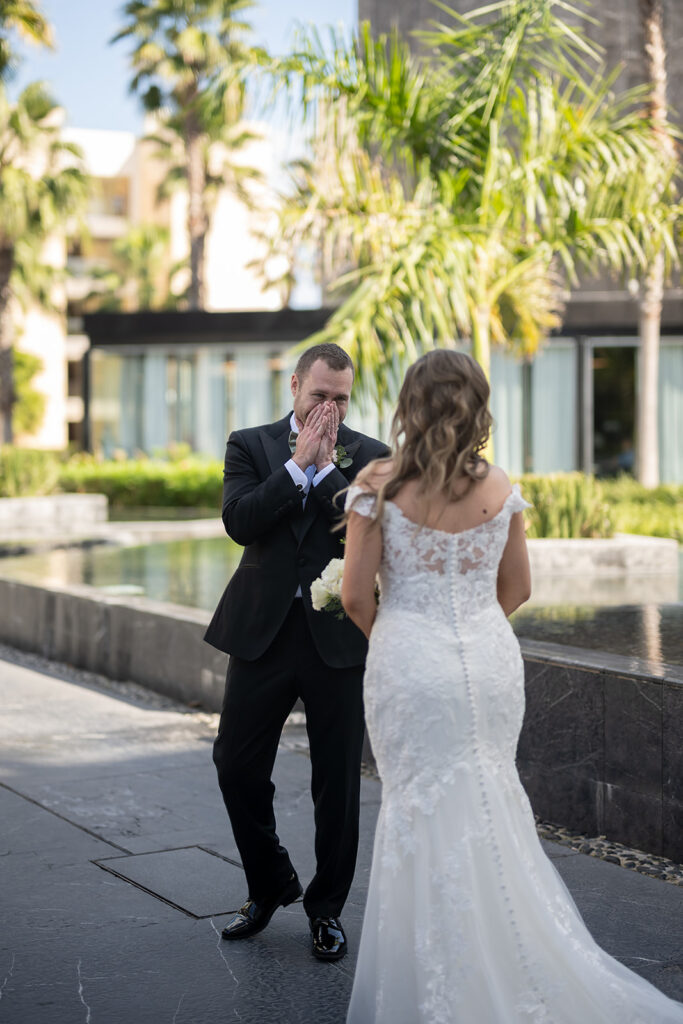 Bride and groom sharing a first look outside of TRS Coral Hotel during their destination Grand Palladium Costa Mujeres wedding