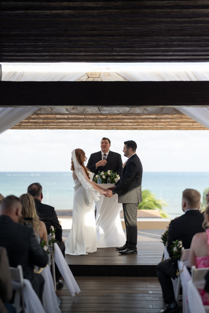 Bride and groom standing at the altar for their Sky Wedding ceremony at Hideaway at Royalton Riviera Cancun
