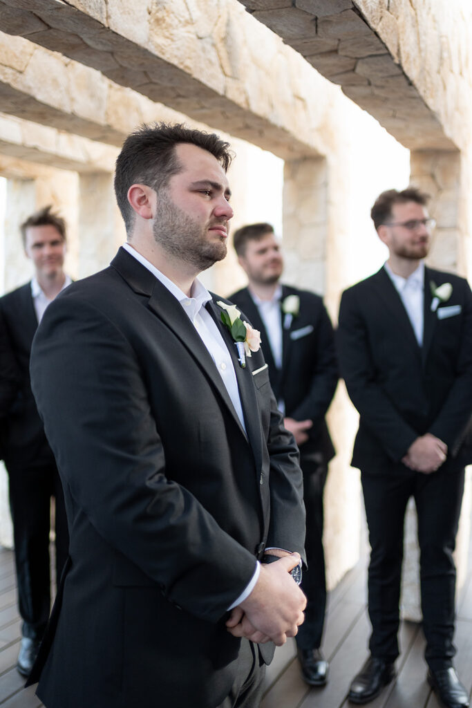 Groom getting emotional as he sees his bride walking down the aisle