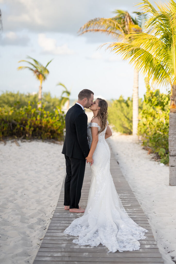 Bride and groom kissing for portraits during their destination Cancun wedding