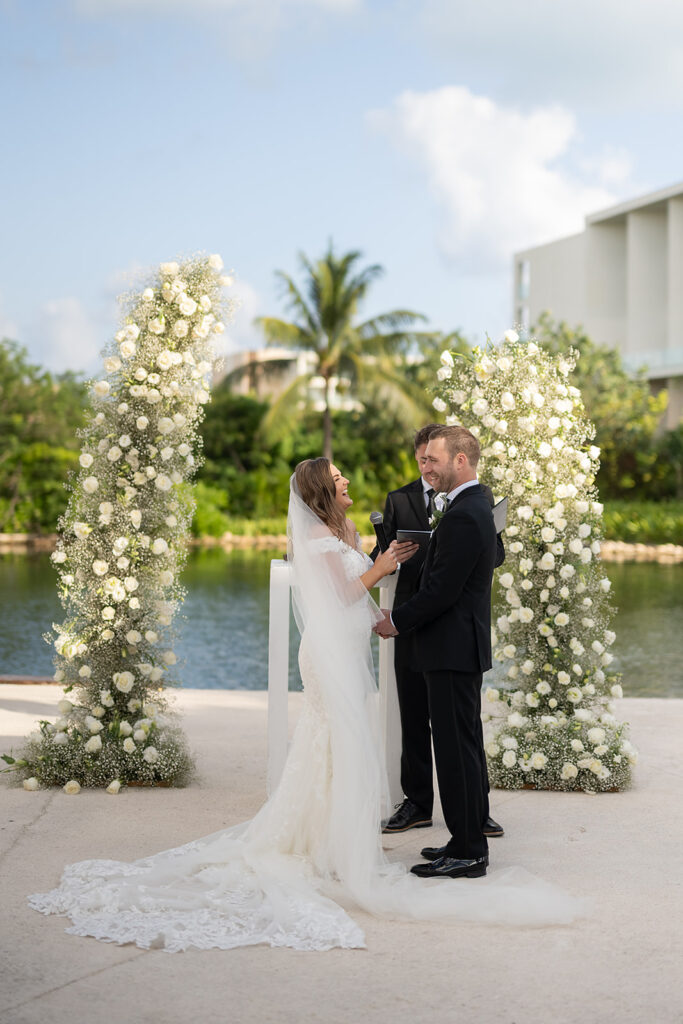 Bride and groom laughing during their outdoor Grand Palladium Costa Mujeres wedding ceremony at Deck in The Village