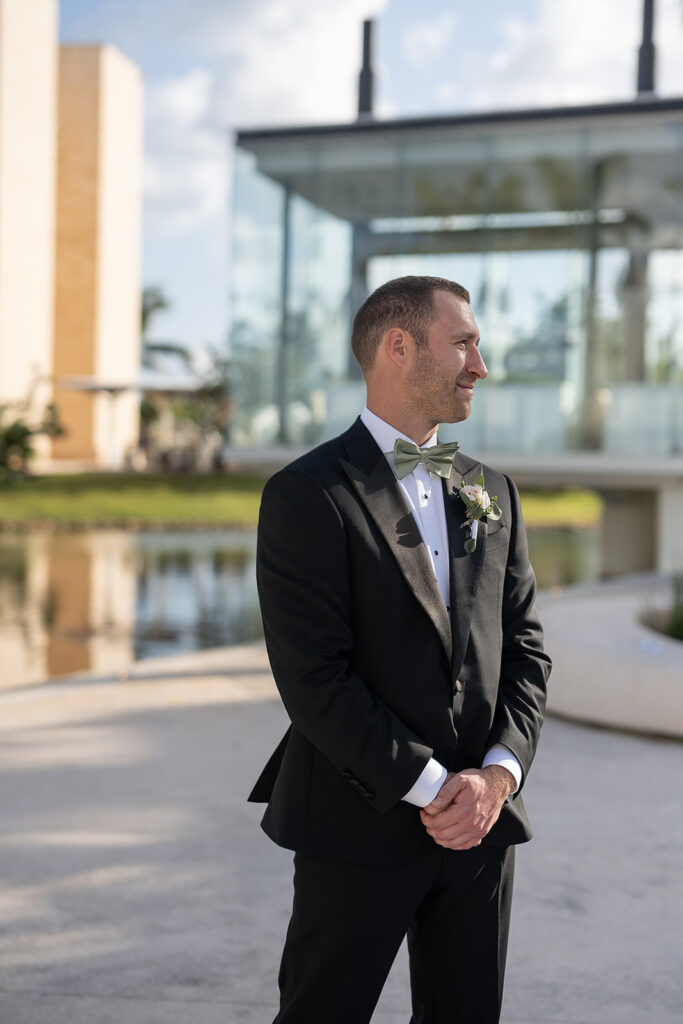 Groom watching his bride walk down the aisle for their outdoor Grand Palladium Costa Mujeres wedding ceremony at Deck in The Village