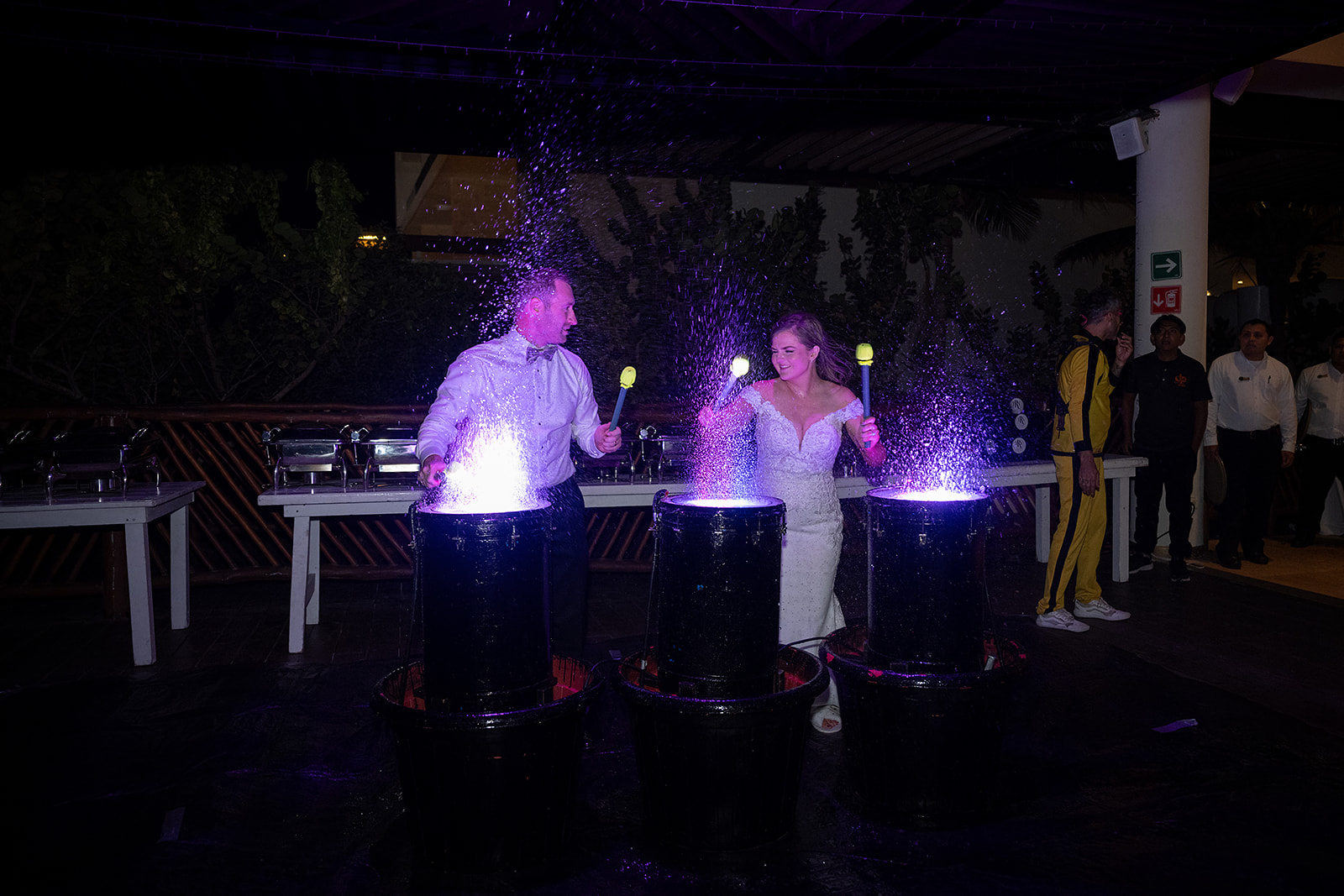 Bride and groom doing a water drumming performance
