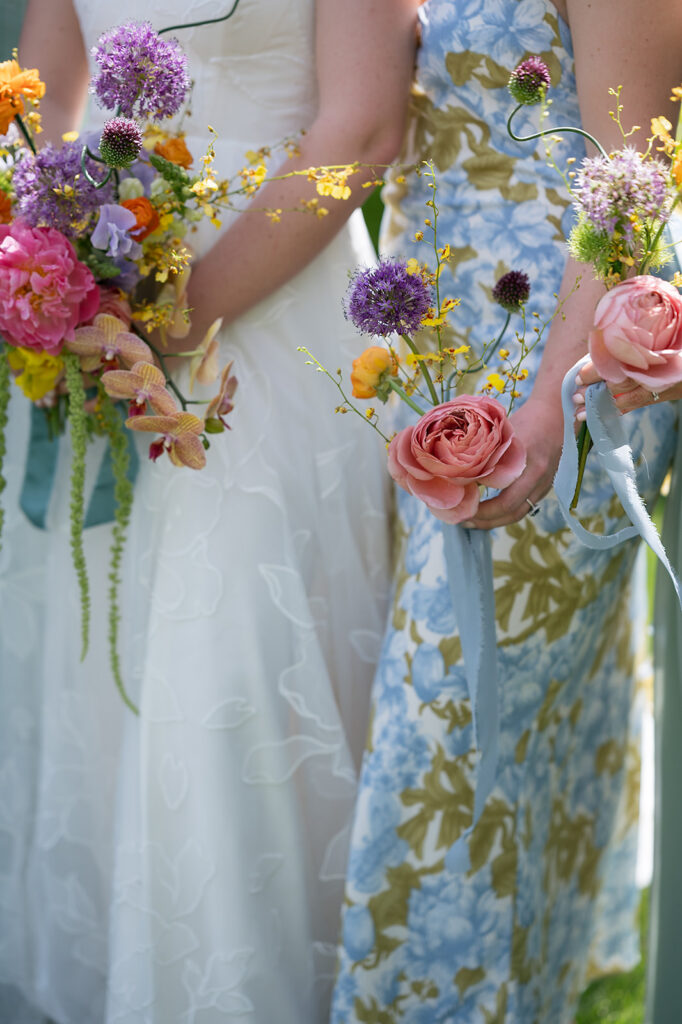 Bride and bridesmaids holding colorful wedding bouquets from a colorful Asheville wedding