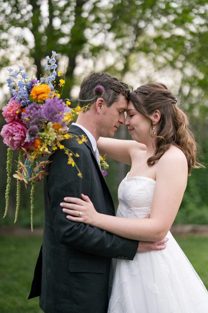 Bride and groom posing outdoors for their portraits