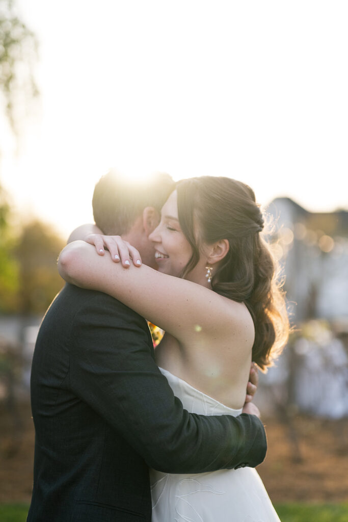 Bride and groom hugging during their golden hour wedding portraits