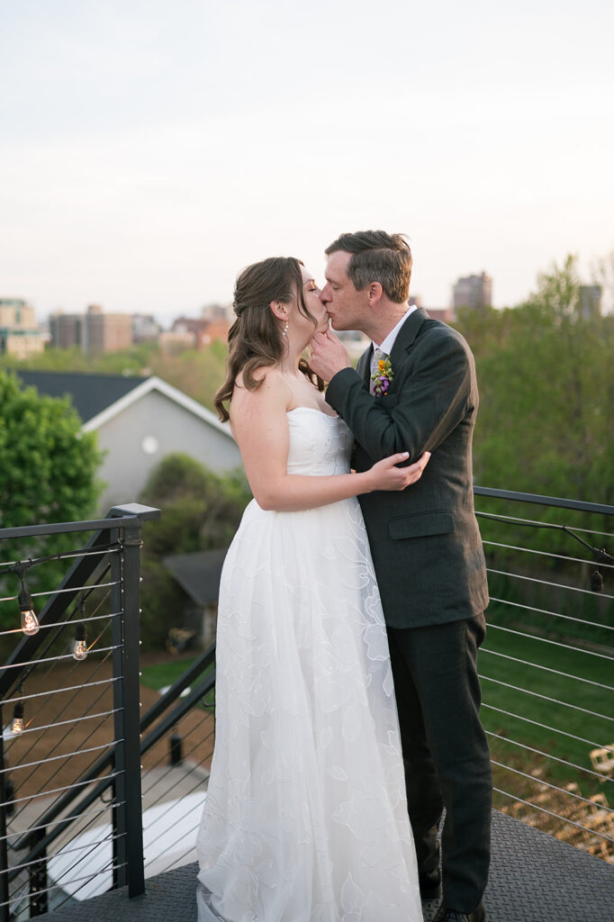 Bride and groom kissing on a rooftop at The Bunn House in Asheville, NC