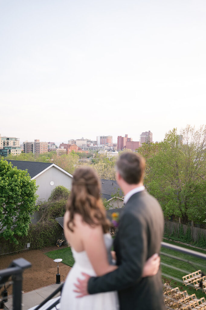 Bride and groom admiring the views of Asheville, NC from the rooftop of The Bunn House
