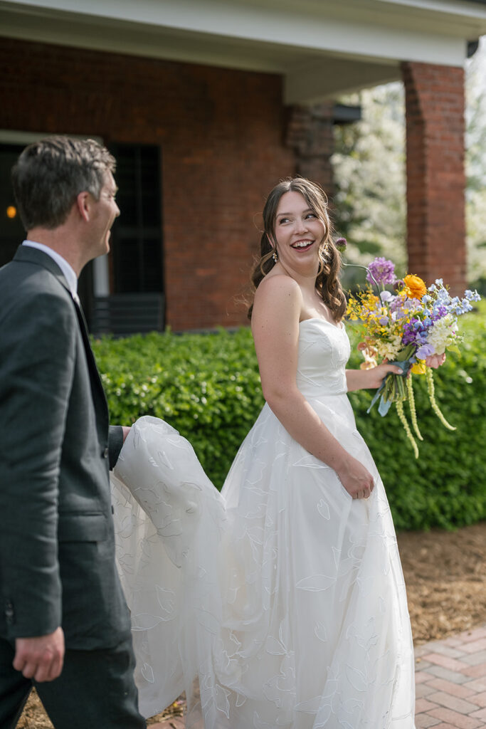 Bride looking back at the groom during their outdoor wedding portraits