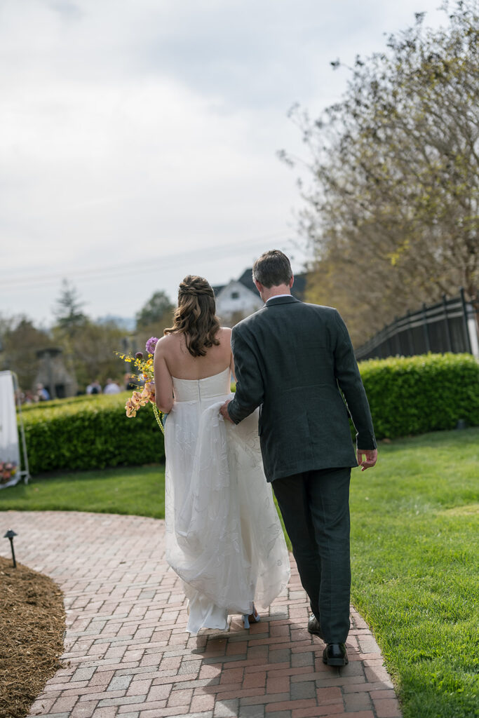 Bride and groom walking a path together