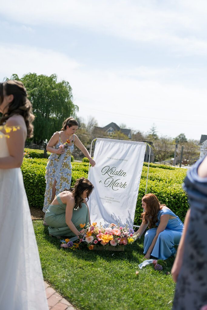 Candid photo of the bridesmaids fixing a floral box