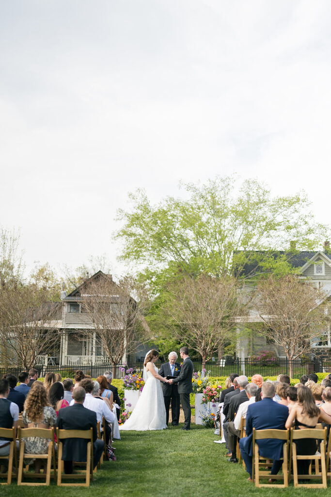 Bride and groom holding hands during their Asheville micro wedding ceremony at The Bunn House