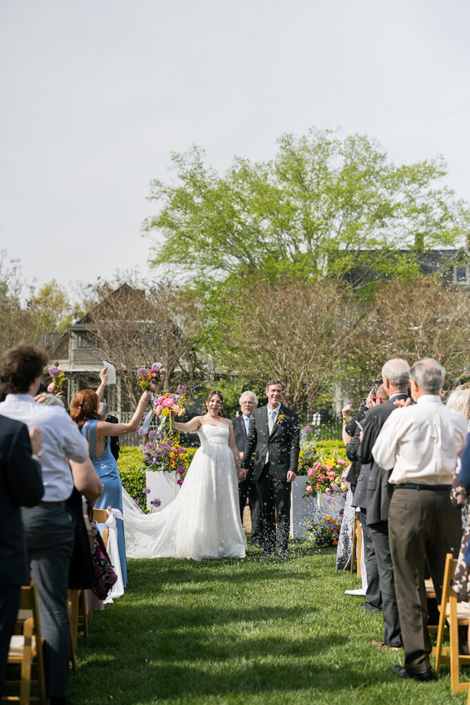 Just married moment with couple raising hands in celebration at The Bunn House ceremony