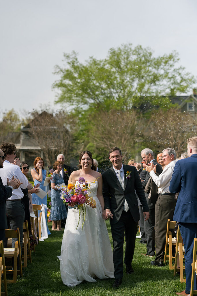 Bride and groom walking back down the aisle as husband and wife