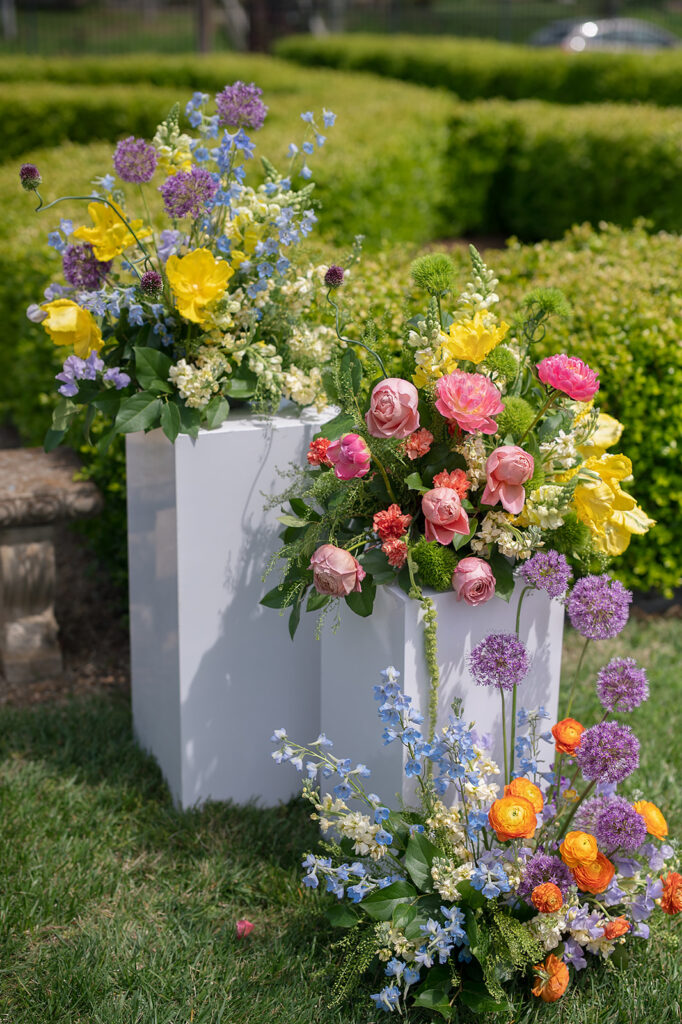 Colorful spring wedding ceremony florals in white boxes