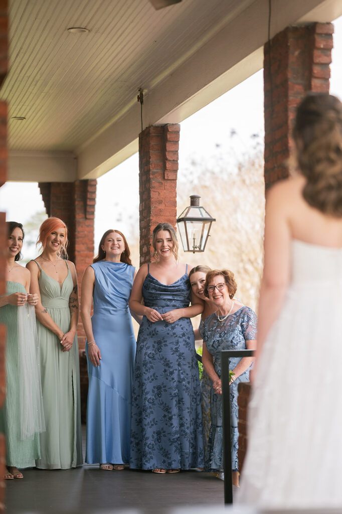 Bride sharing a first look with her mother and bridesmaids