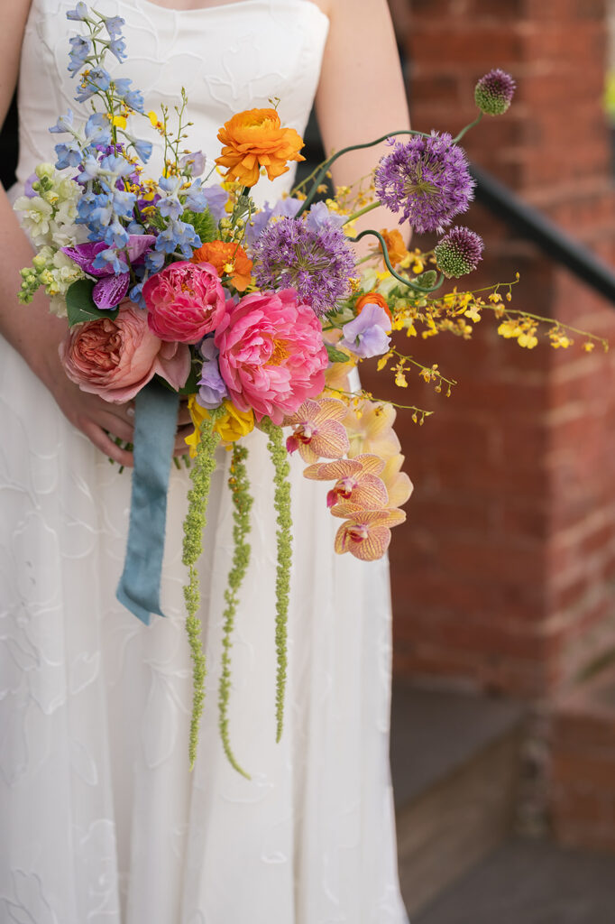 Bride holding her colorful spring wedding bouquet for her Asheville wedding photos at The Bunn House