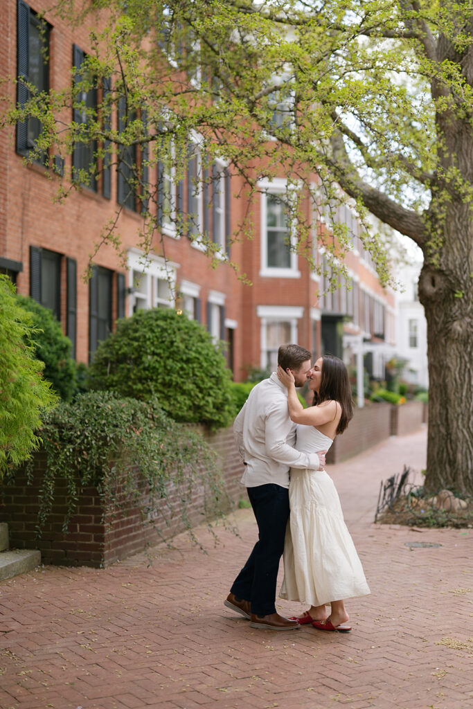 Couple kissing during their outdoor engagement photos in Washington DC
