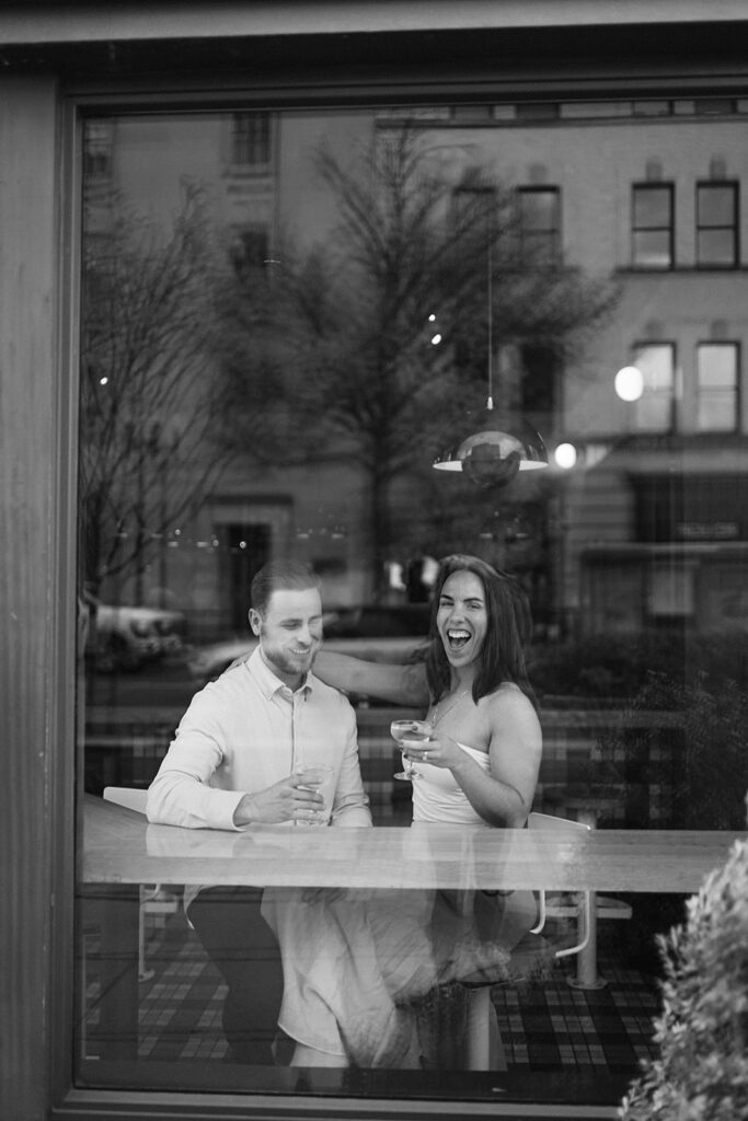 Couple having drinks at Jane Jane for their engagement photos in Washington DC