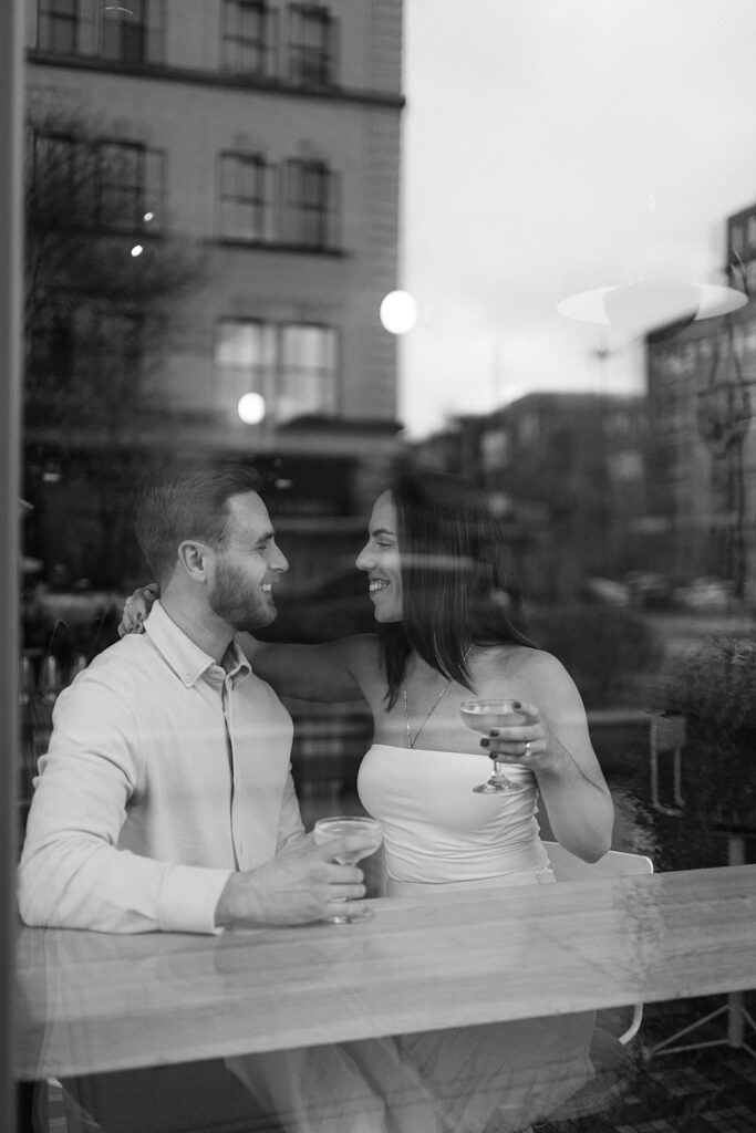 Couple having drinks at Jane Jane for their engagement photos in Washington DC