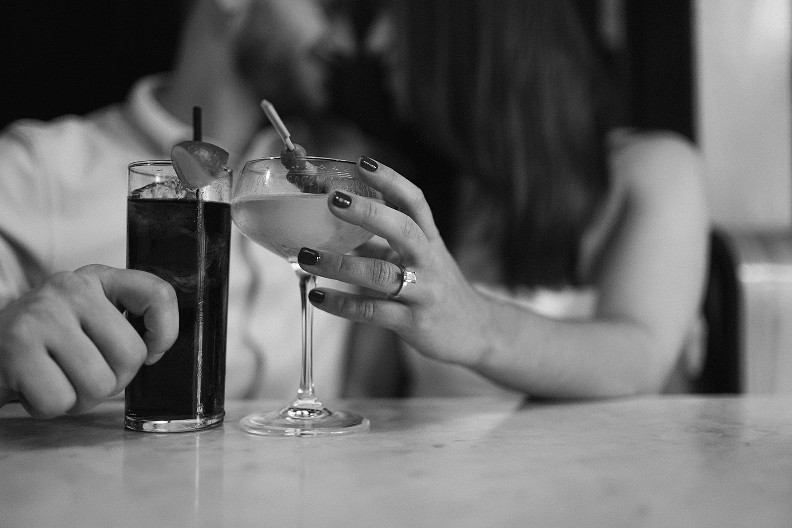 Black and white photo of a couple having drinks at a cocktail bar in DC