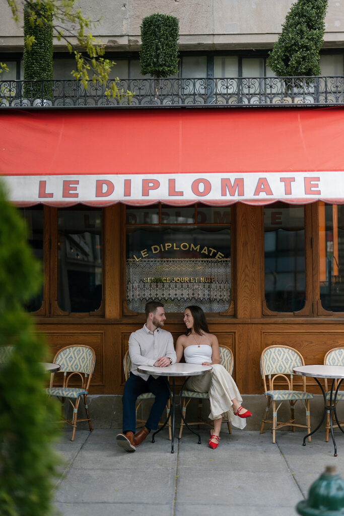 Couple posing outside of Le Diplomate for their engagement photos in Washington DC