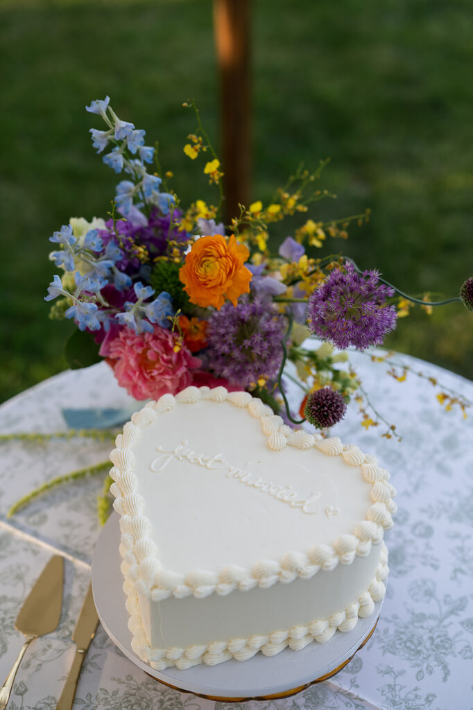 Heart shaped wedding cake with colorful spring florals