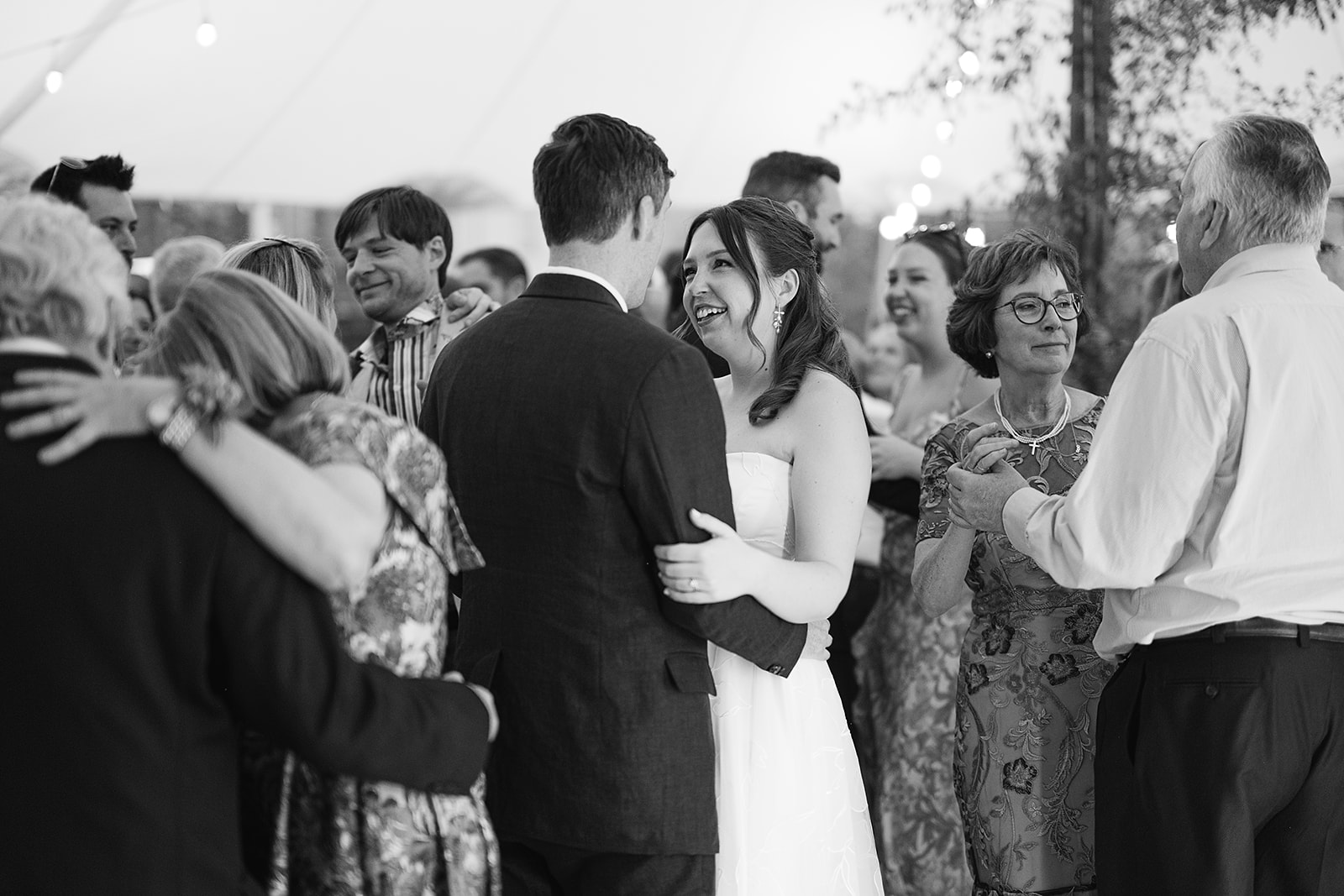 Black and white photo of a bride and groom dancing