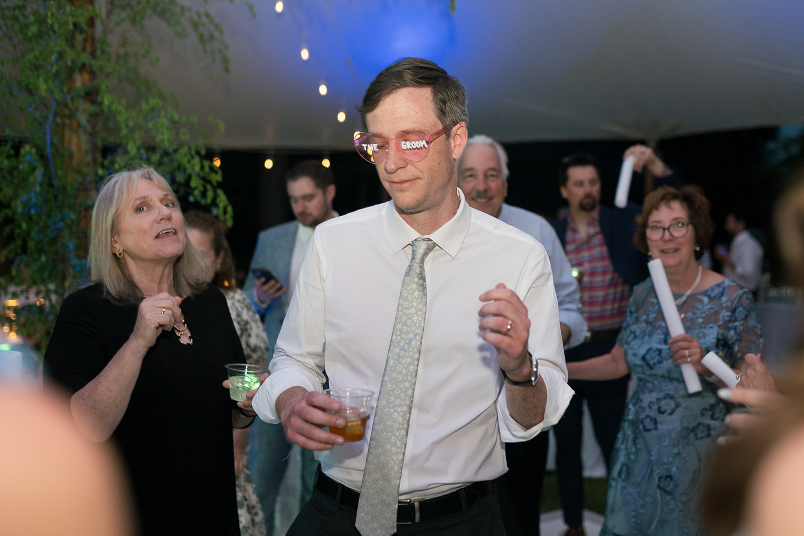 Groom dancing with heart shaped-sunglasses