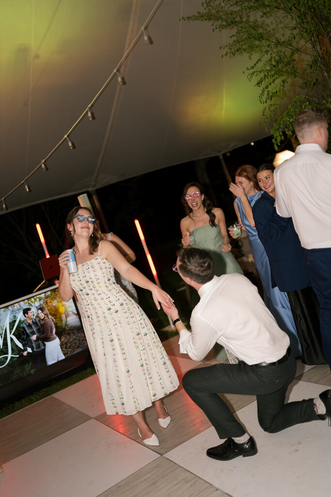 Groom pretending to propose during their reception