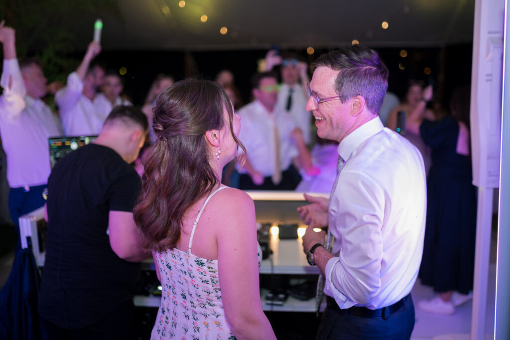 Bride and groom playing music from the DJ booth