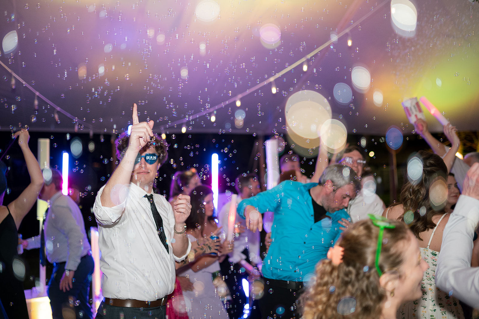 Guests dancing during a wedding reception with bubbles