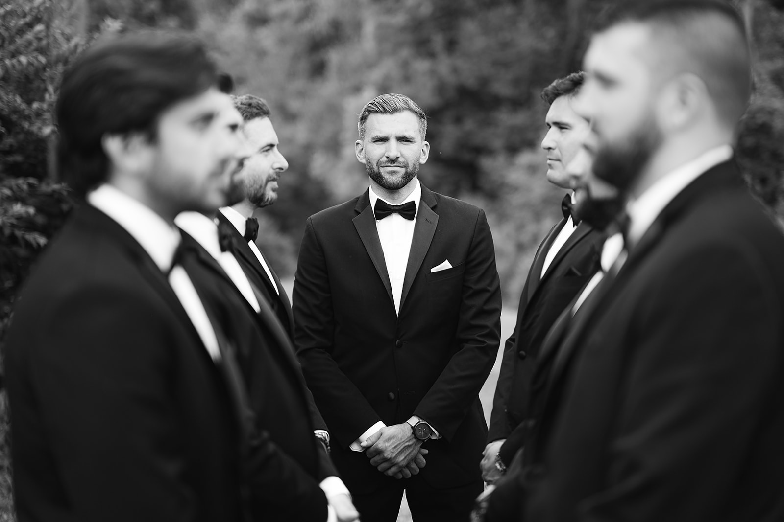 Black and white portrait of groom surrounded by groomsmen at Daniel’s Vineyard
