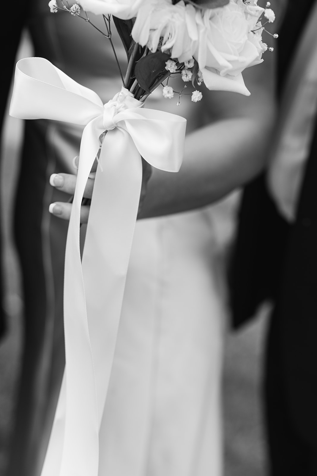 Black and white bouquet close-up with ribbon and roses at Daniel’s Vineyard wedding