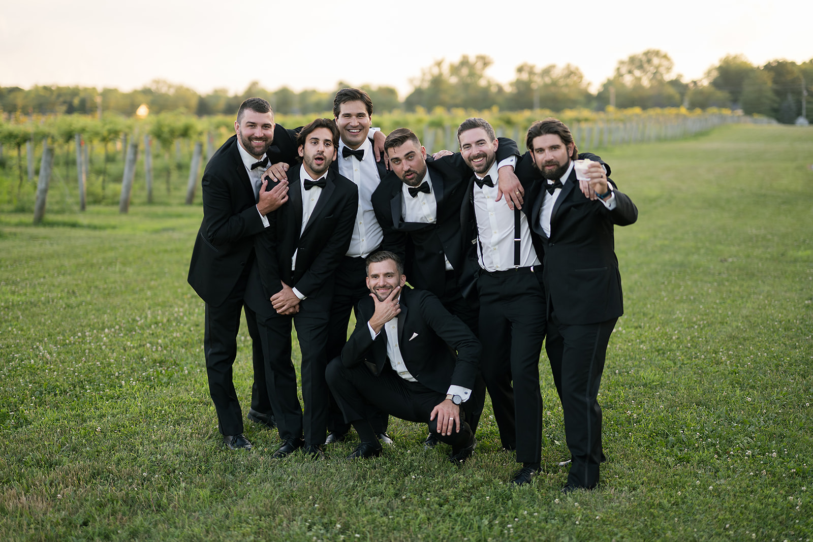 Golden hour groom and groomsmen photo at Daniel's Vineyard wedding venue in Indiana