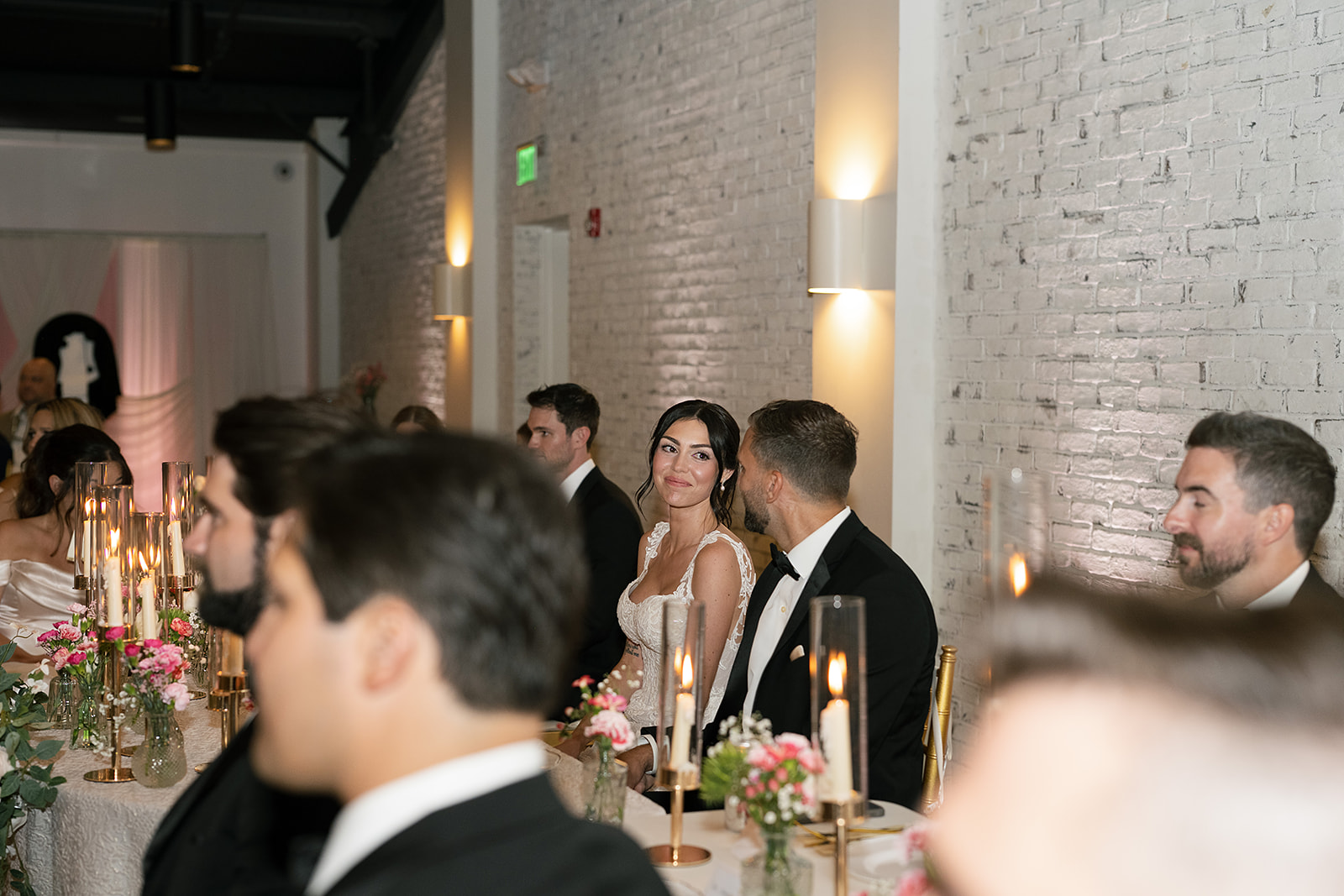 Bride and groom smiling at each other during their Daniel's Vineyard wedding reception