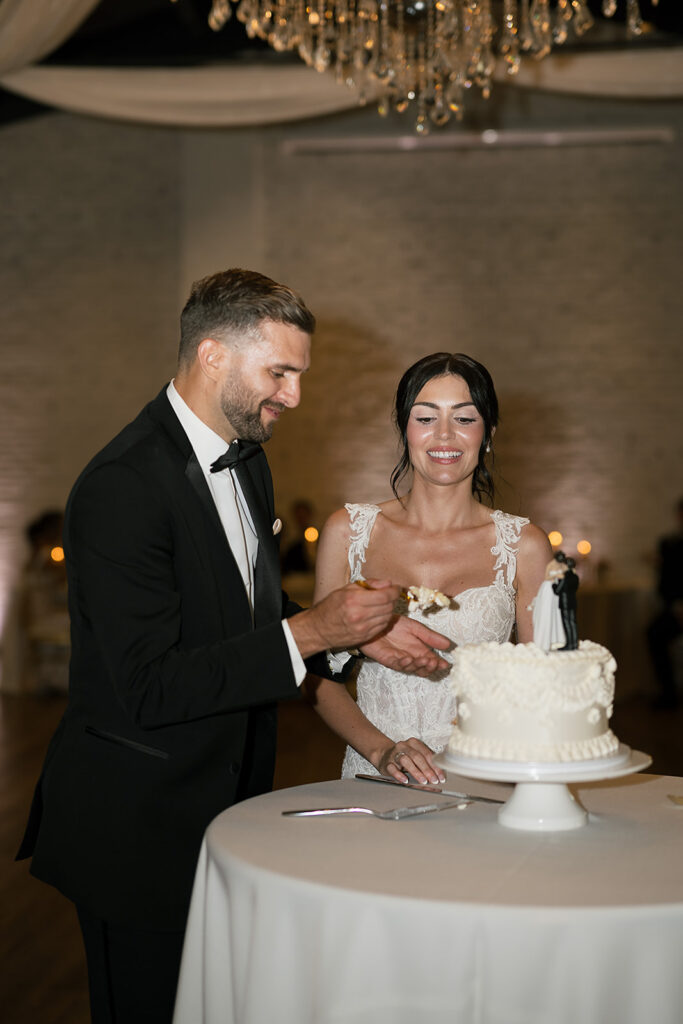 Bride and groom cutting into their wedding cake