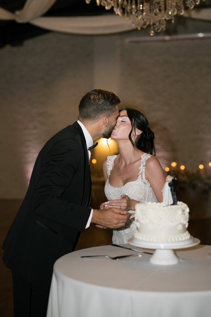 Bride and groom kissing during their wedding reception