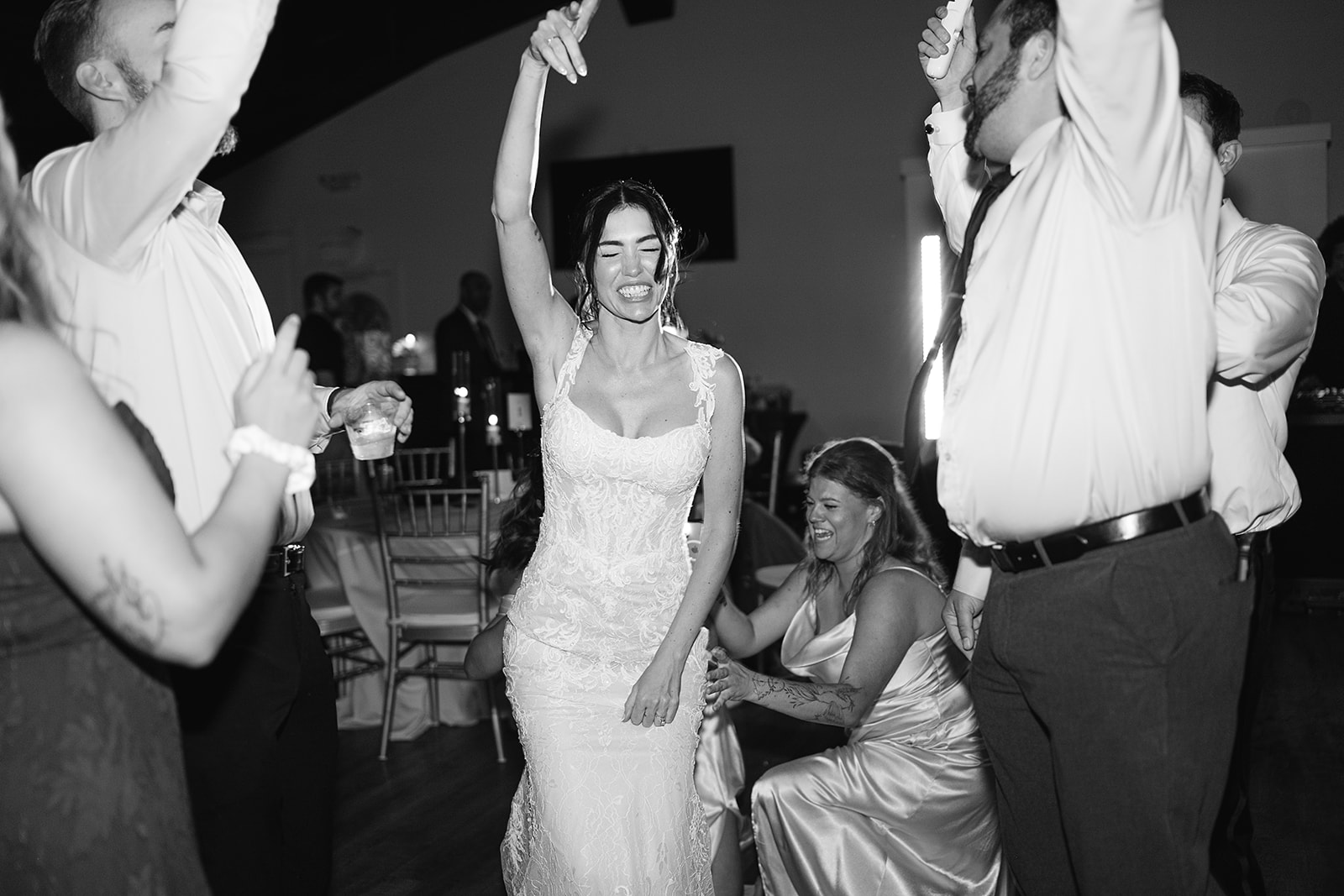 Black and white photo of the bride dancing during her reception