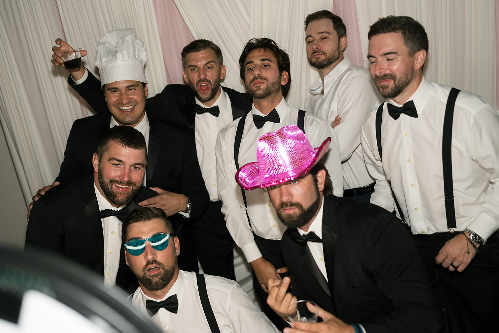 Groom posing with his groomsmen during the reception