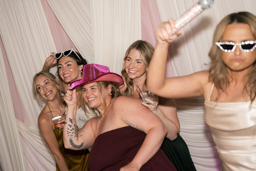 Bride posing with guests during reception 