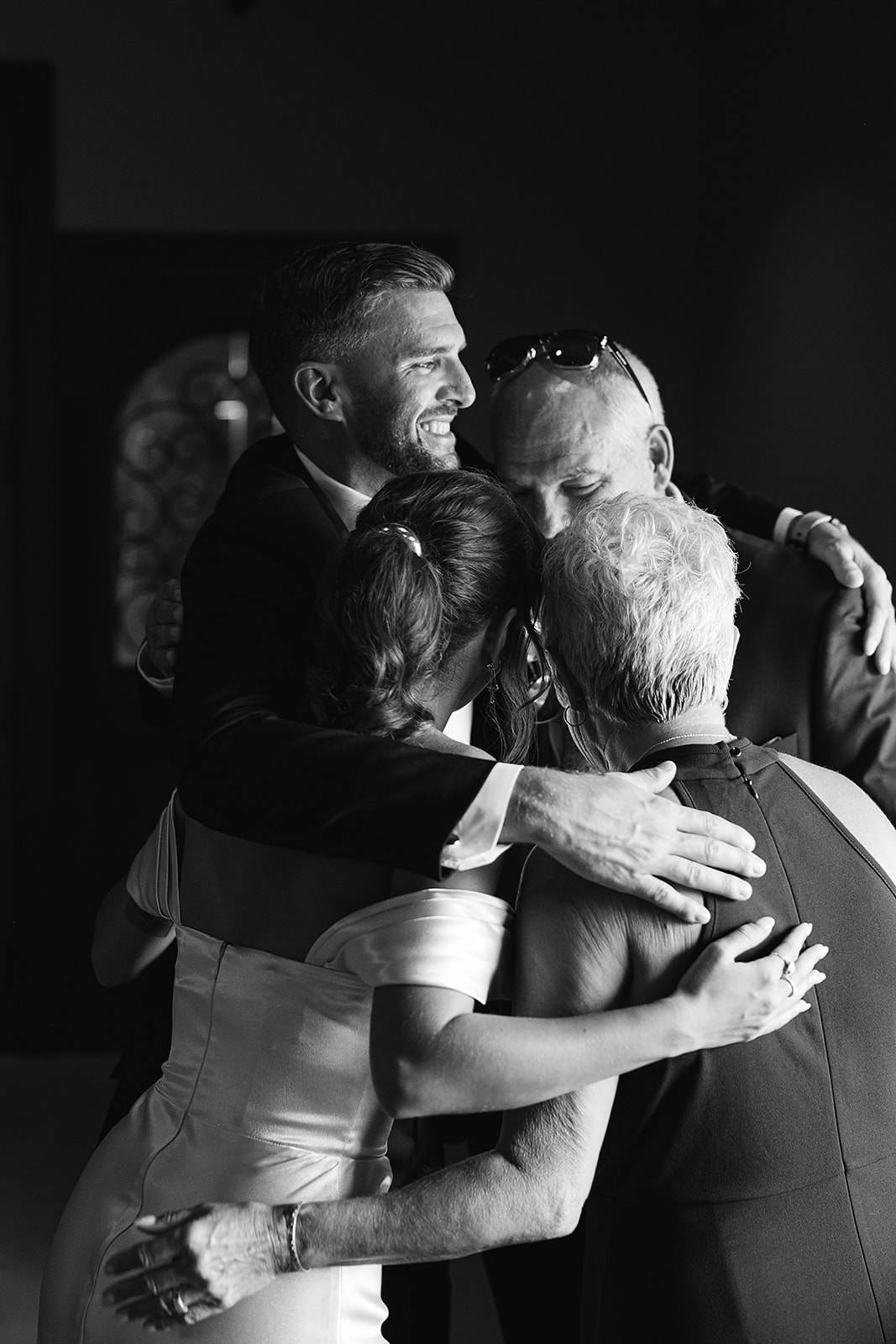 Black and white photo of family embracing during an Indiana wedding at Daniel's Vineyard