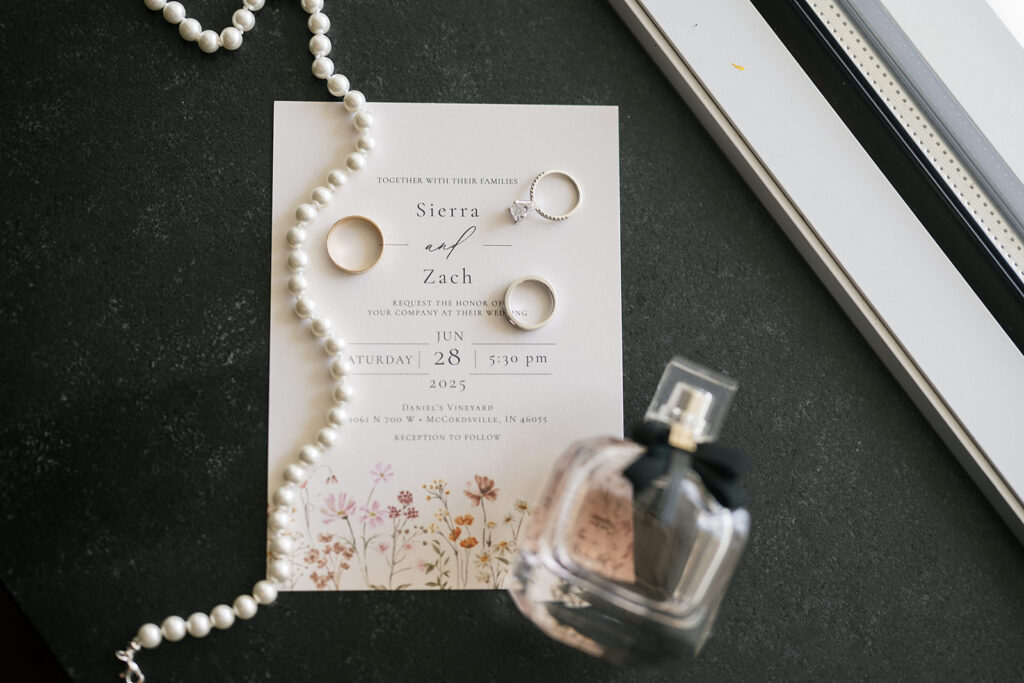 Wedding invitation details including jewelry, rings, and perfume 