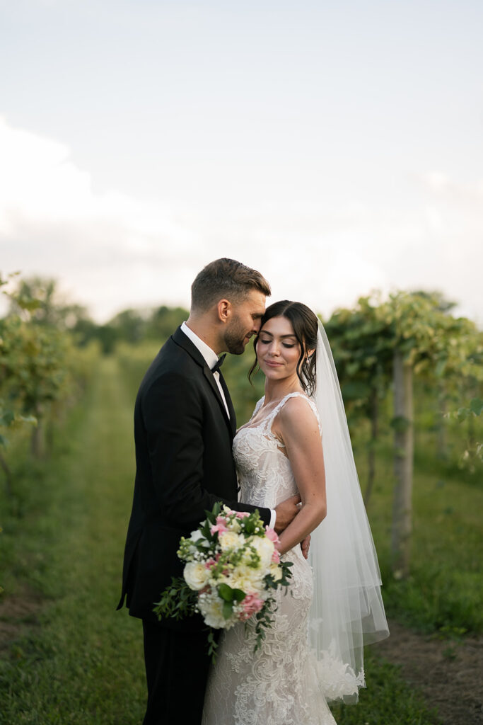 Bride and groom posing in the vines