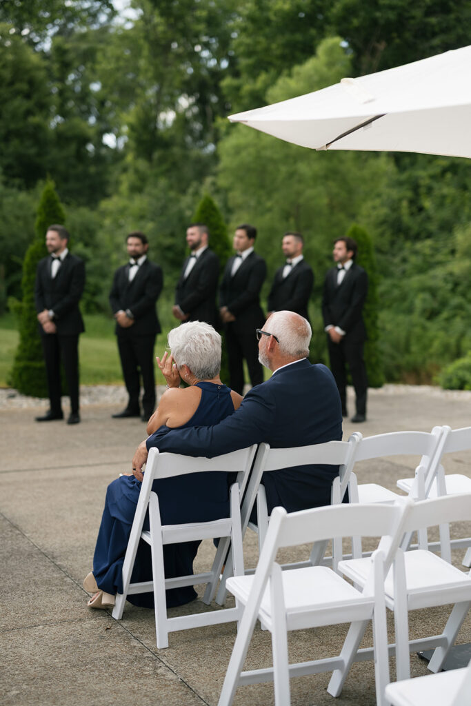 Grooms parents getting emotional as they watch the ceremony