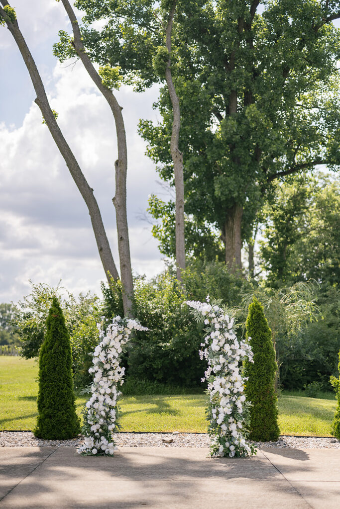 Floral-covered wedding arbor surrounded by greenery at Daniel’s Vineyard Ceremony Pad