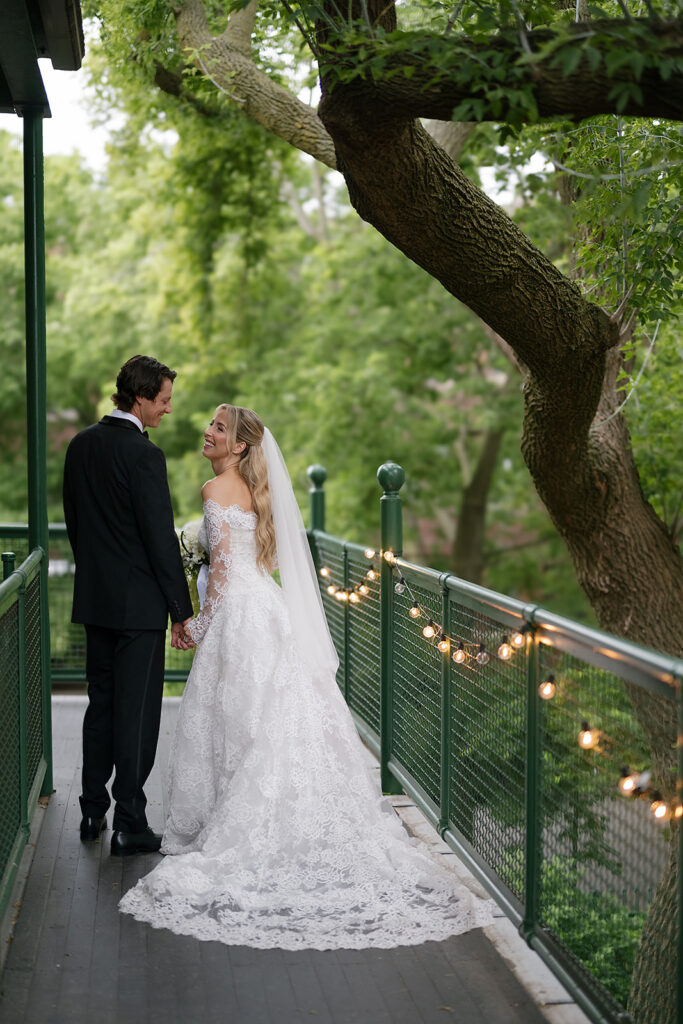 Bride and groom walking along the balcony at Chicago Firehouse